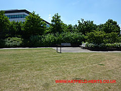 Board 7 by the benches in the garden area next to the T-Mobile Orange offices