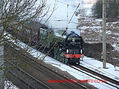 Tornado steam engine - painted apple green - passing through a snowy south Hatfield