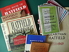 Array of books on Hatfield set against a green background