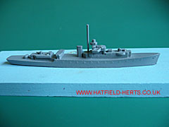 Diecast model of a River class frigate in grey metal on a blue painted wooden base