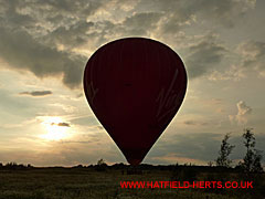 Balloon on the ground, seen in silhouette