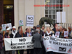 Close up section of the crowd in front of the entrance with banners and placards