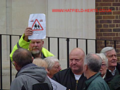 Protestor holding up a protest leaflet