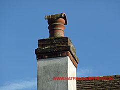 Terracotta pot with similar hood or bonnet - resembles a chimney pot cut in half and placed on top of the pot