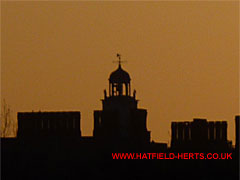 Chimney stacks with rows of pots on Hatfield House, early morning silhouette
