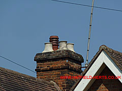 Stack on Bush Hall with 3x light colour round pots with square bases and 1x terracotta pot with louvre