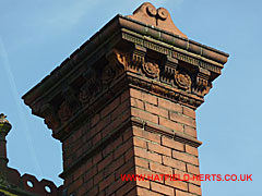 Close up of brick and terracotta edging square chimney