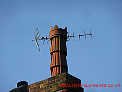 Tall terracotta pot with fluted sides in three bands or rings with a spiked crown