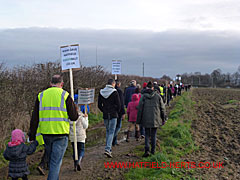 marchers setting off across the footpath off Green Lanes - by West Lodge