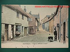 Colourised postcard view of the Arm and Sword yard